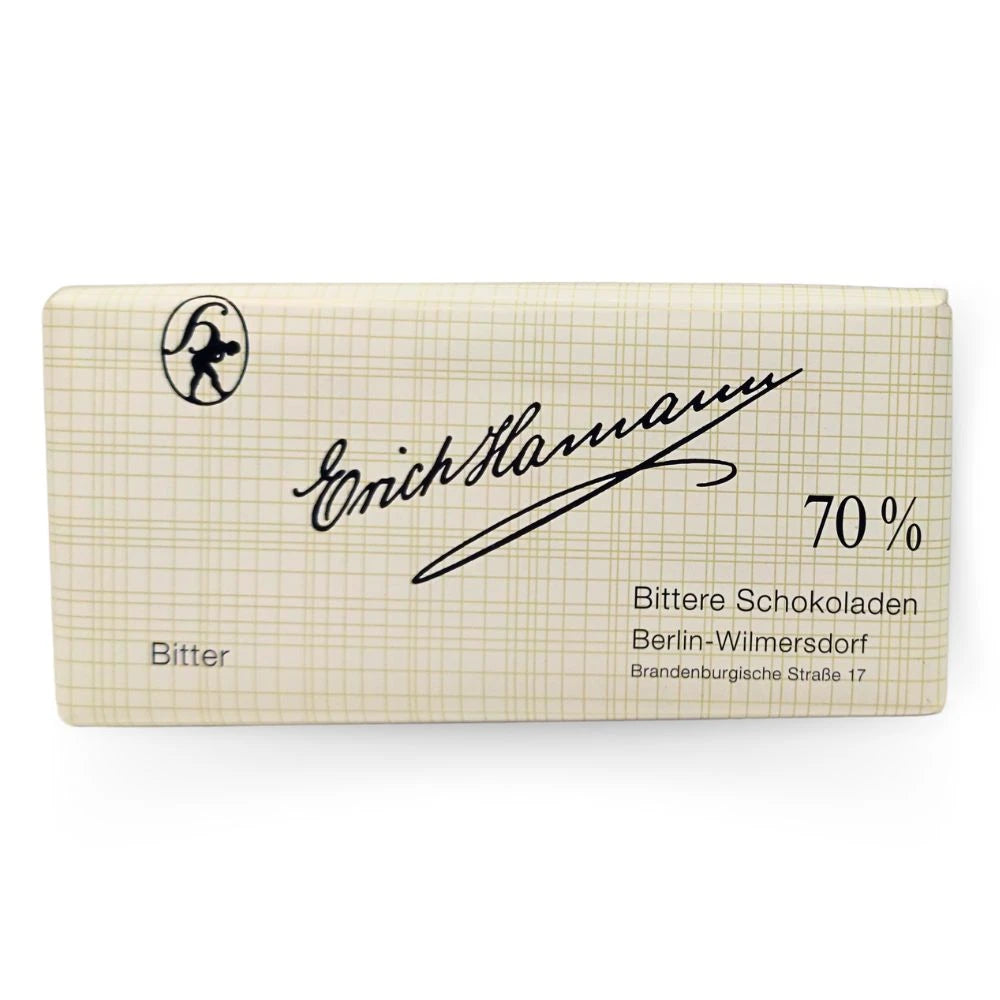 Erich Hamann Bitterschokolade 100 g – stilvoll verpackt in cremefarbener Gitterpapierhülle mit schwarzer Handschrift. 70 % Kakao, hergestellt in Berlin-Wilmersdorf.
