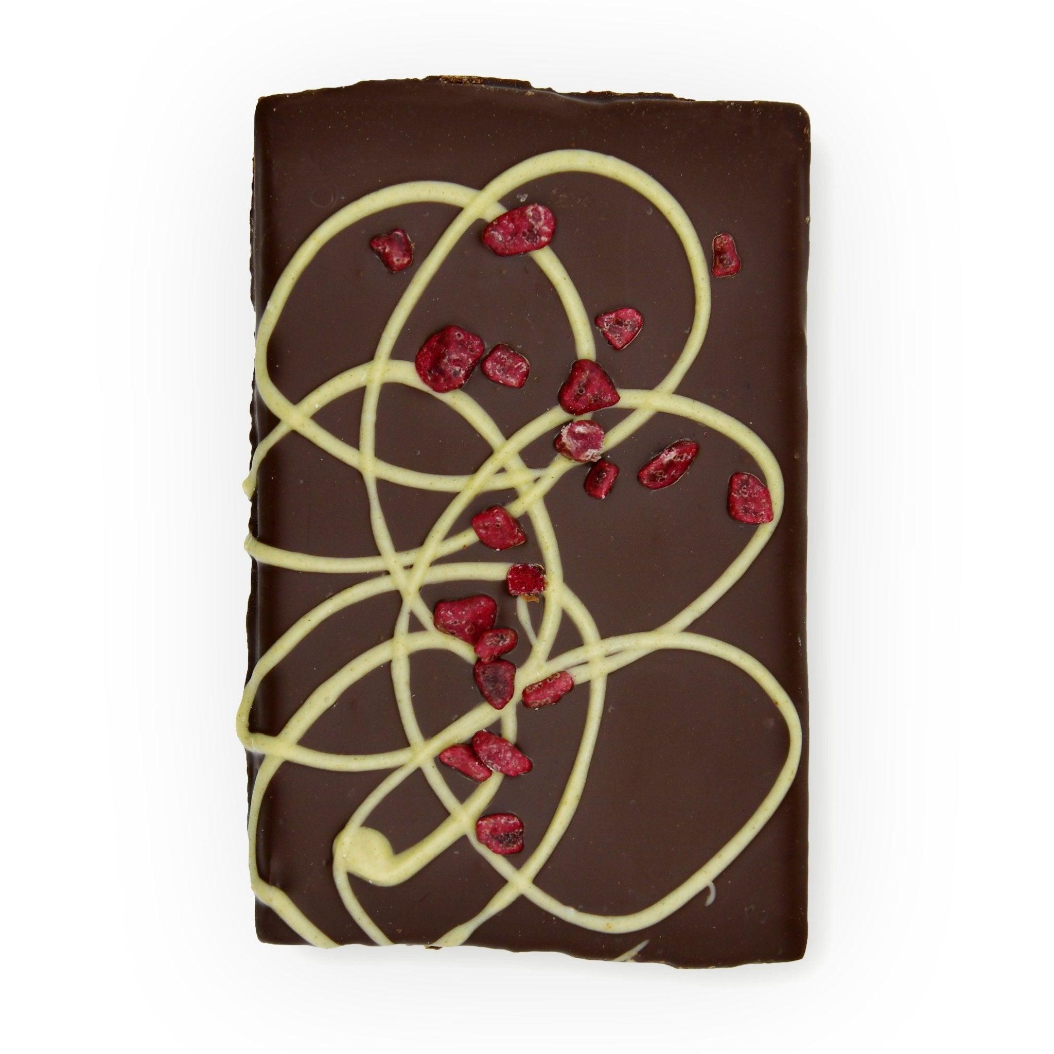 Obenansicht der Zartbitter-Schokolade mit Kirsche-Minze-Füllung – ein Genussprodukt aus Berliner Manufaktur, modern inszeniert.