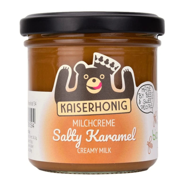 Milchcreme Salty Karamel im 175g-Glas von Kaiserhonig, orangefarbenes Etikett mit schwarzem Schraubdeckel und fröhlichem Markenbären mit Krone.