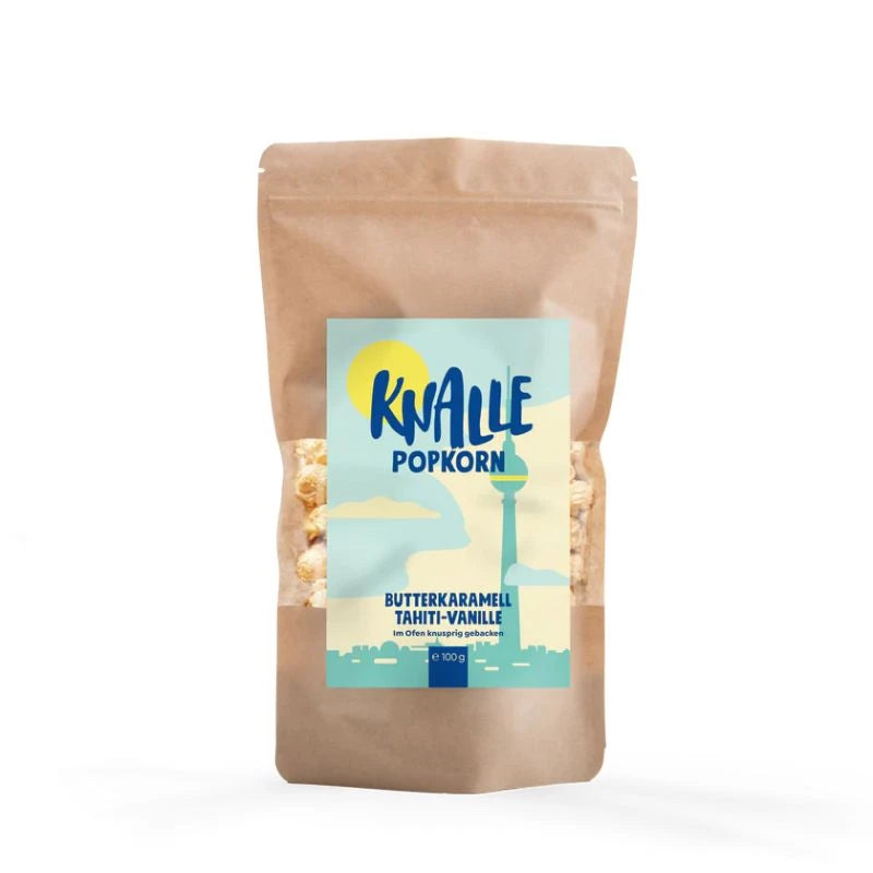 Knalle Popkorn Butterkaramell Tahiti-Vanille in der Berlin Edition – 100 g Packung im braunen Standbeutel mit blauer Skyline-Etikettierung. Handgemacht in Berlin, im Ofen gebacken.